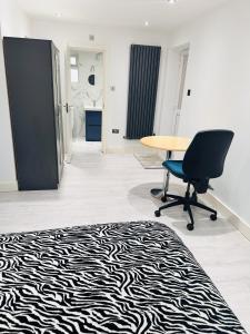 an office with a desk and a chair and a zebra rug at Large Double Bed En-suite Room 20 mins from Heathrow in Burnham