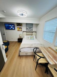 a bedroom with a bed and a table in it at Cozy Villa with Spa, Fireplace, Kitchen, Yard, BBQ in Simi Valley