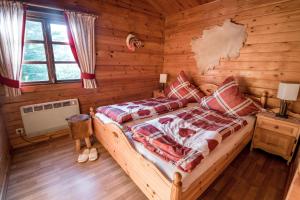 a bedroom with a bed in a log cabin at Hirsch Chalet in Bömighausen +29 photos