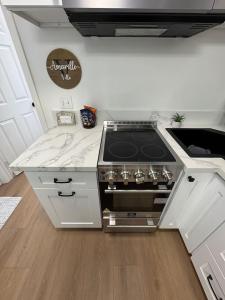 a kitchen with a stove and a counter top at Cozy Villa with Spa, Fireplace, Kitchen, Yard, BBQ in Simi Valley