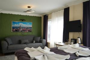 a hotel room with two beds and a couch at The Apartment Galata in Istanbul