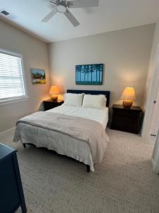 a bedroom with a large bed with two night stands at Endicott Cottage in Richmond
