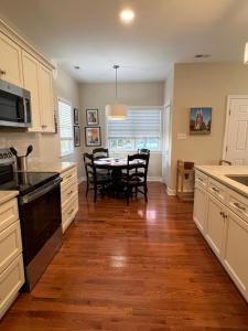 a kitchen with a table and chairs in it at Endicott Cottage in Richmond +2 photos