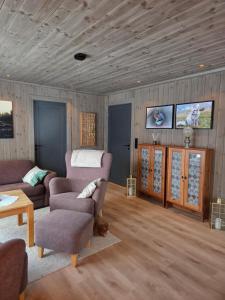a living room with a couch and a table at Harteigen cabin Lofoten retreat in Vestvågøya