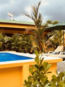 a resort with a swimming pool and a building at Casitas Amarillas in Uvita