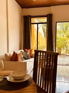 a living room with a couch and a table at Casitas Amarillas in Uvita