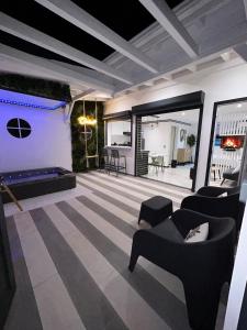a living room with couches and a pool table at Obonheur avec Jacuzzi in Le Gosier