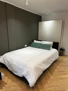 a bedroom with a large bed with white sheets at Ayia Napa Neo Classical Studio in Ayia Napa