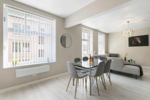 a dining room and living room with a table and chairs at Centrum apartment 2 in Ålesund +17 photos