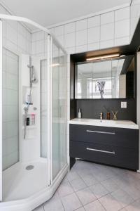 a bathroom with a shower and a sink at Centrum apartment 2 in Ålesund