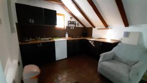 a kitchen with a couch and a table in a room at Apartman Kamen 1 in Negotin