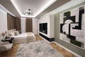 a bedroom with a bed and a tv and a couch at NestOne - Apartment hotels in Tashkent