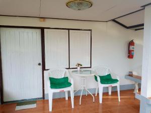 two chairs and a table in a room at Pineapple Resort Sam roi yot in Sathani Sam Roi Yot