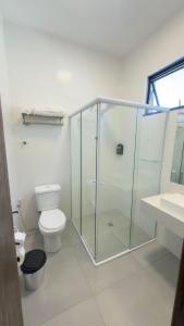 a bathroom with a glass shower and a toilet at Ibirama Vale Hotel in Ibirama