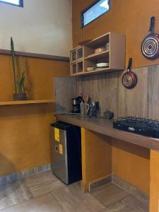 a kitchen with a counter top and a stove at El Bungalow de Juana in Tepoztlán