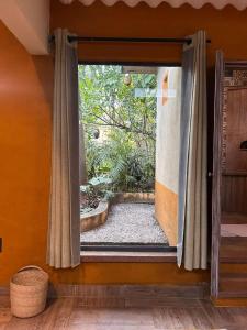an open door to a garden in a room at El Bungalow de Juana in Tepoztlán
