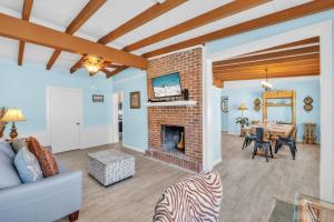 a living room with a brick fireplace and a dining room at Island Gem B home in Anna Maria