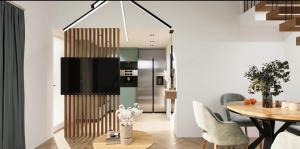 a kitchen and dining room with a table and chairs at WBR Apartlak in Villány +4 photos