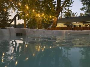 an empty swimming pool with the sun reflecting on the water at The Hourglass Inn- Unit B in Savannah