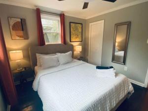 a bedroom with a white bed and a window at The Hourglass Inn- Unit B in Savannah +29 photos