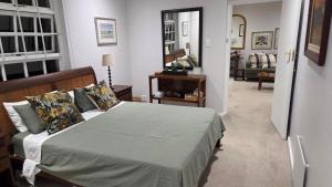 a bedroom with a bed and a living room at Hillcrest Cottage in Constantia