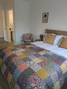 a bedroom with a bed with a colorful quilt on it at Trim private rooms in Trim +43 photos