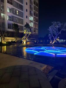 a row of blue lights in the water at night at 221B Baker in Ấp Phú Thọ