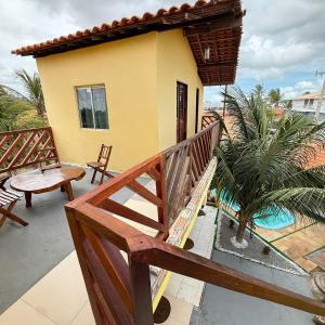 a house with a wooden staircase leading to a porch at Sertão beach in Tutóia