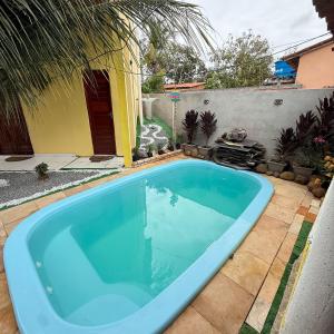 a large blue swimming pool in a yard at Sertão beach in Tutóia