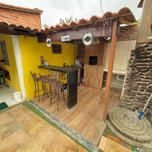an outdoor kitchen with a table and chairs on a deck at Sertão beach in Tutóia