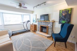 a living room with a couch and a fireplace at Langley Suite with Full Kitchen in Langley