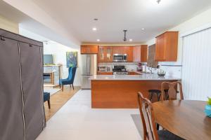 an open kitchen and dining room with a table and chairs at Langley Suite with Full Kitchen in Langley