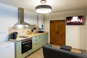 a kitchen with a sink and a stove top oven at Zselic Kuckó by Mártika in Szigetvár +24 photos
