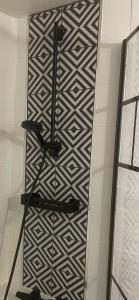 a wall with a black and white pattern at La Parenthèse in Chalons en Champagne