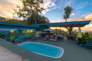 a house with a swimming pool and a patio at Vista del Pacifico Boutique Hotel in Quepos