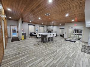 a large room with a table and chairs in it at Baymont by Wyndham Baldwin in Baldwin