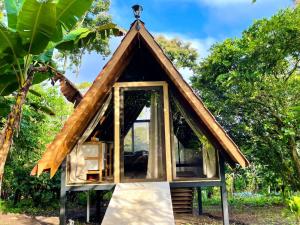 a small house with a thatched roof at Cabañas Toku Laka in Fortuna +14 photos