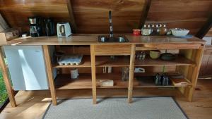 a wooden counter with a sink in a room at Cabañas Toku Laka in Fortuna