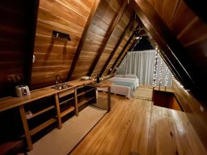 a bathroom with a sink and a bed in a room at Cabañas Toku Laka in Fortuna