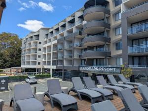 a row of chairs in front of a building at Landmark Resort 518 - Casablanca Penthouse 5th Floor in Nelson Bay