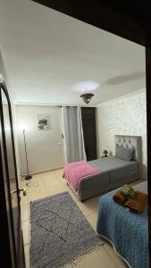 a bedroom with two beds and a rug at Appartement 6 personnes piscine hivernage Marrakech in Marrakesh +41 photos