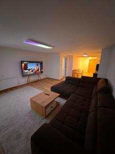 a living room with a couch and a flat screen tv at Modern Apartment 2 Graf - New!! in Grafenwöhr +42 photos