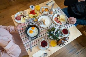 a table full of breakfast foods on a table at Landhouse Bled - Adults Only in Bled