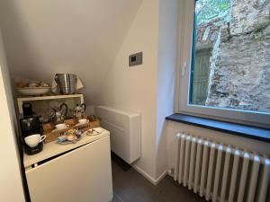 a small kitchen with a window and a radiator at Oblò Portovenere Guesthouse in Portovenere
