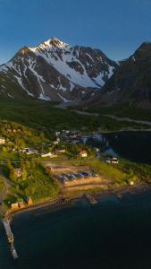 an aerial view of a resort with a mountain at Lyngen Aurora Resort in Koppangen