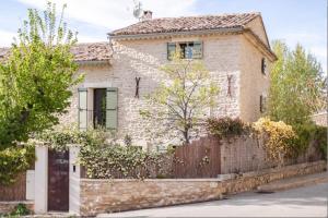 an old stone house with a wooden fence at Coudignac 1891 in Lagnes