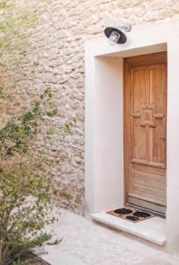 a wooden door in a stone building with a window at Coudignac 1891 in Lagnes +30 photos