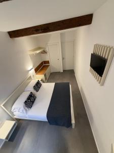 a small bedroom with a bed and a tv at Oblò Portovenere Guesthouse in Portovenere +34 photos