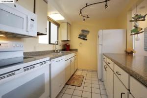 a kitchen with white appliances and a white refrigerator at Stunning 2BD 2BA Ocean Front Condo Great View, AC in Wailuku