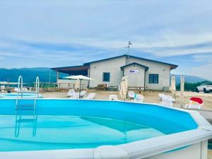 a pool in front of a house with a building at Casa Tucci b&b in Serra San Bruno